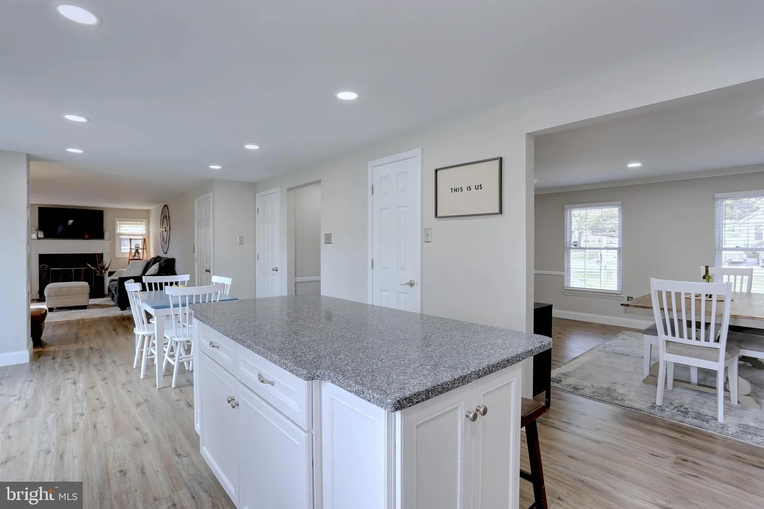 a kitchen with a table chairs refrigerator and microwave