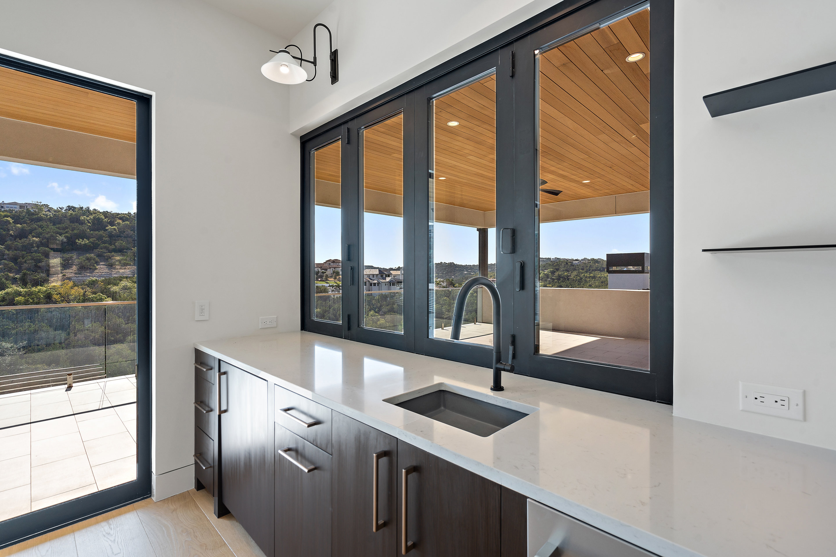 1905 Hallam Drive Austin, TX 78746 - Photo 18 of 39 a view of a kitchen with a sink and large window