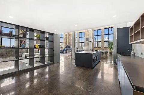 a living room with furniture and a book shelf