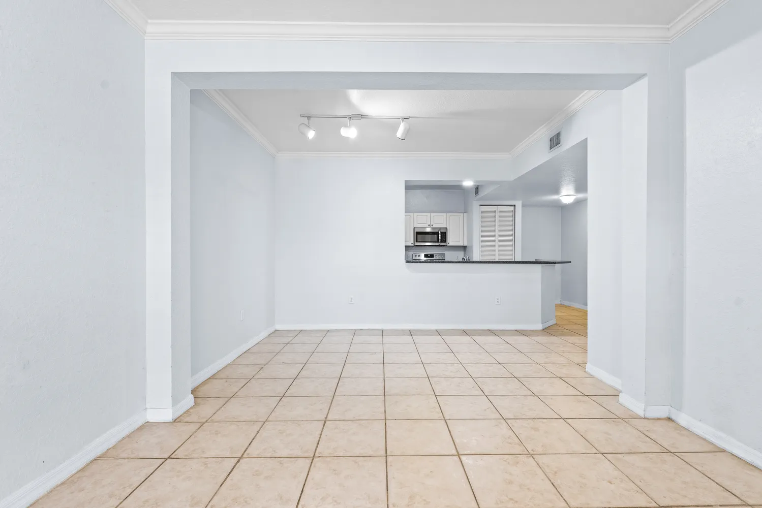a view of kitchen with white cabinets
