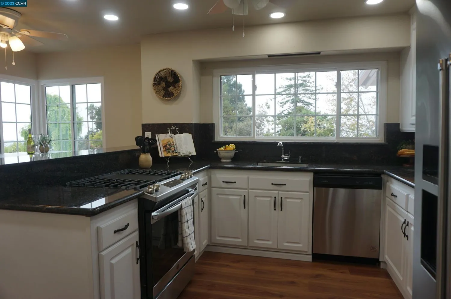 a kitchen with granite countertop a stove and a sink