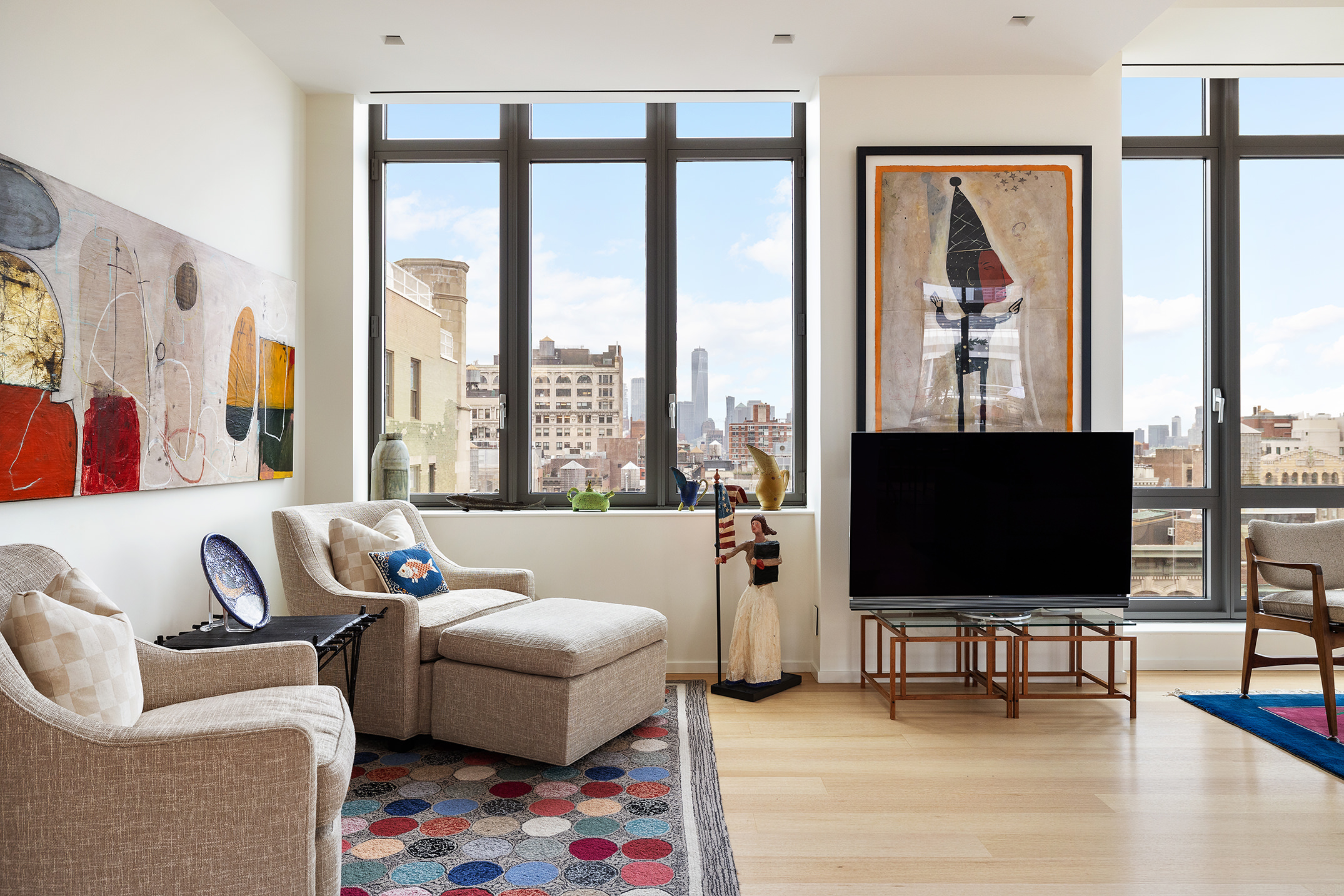 4 West 21st Street, Unit PH Manhattan, NY 10010 - Photo 3 of 14 a living room with furniture and a flat screen tv