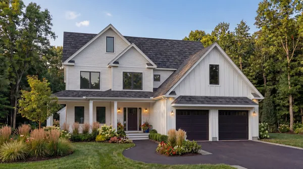 a front view of a house with a yard and garage