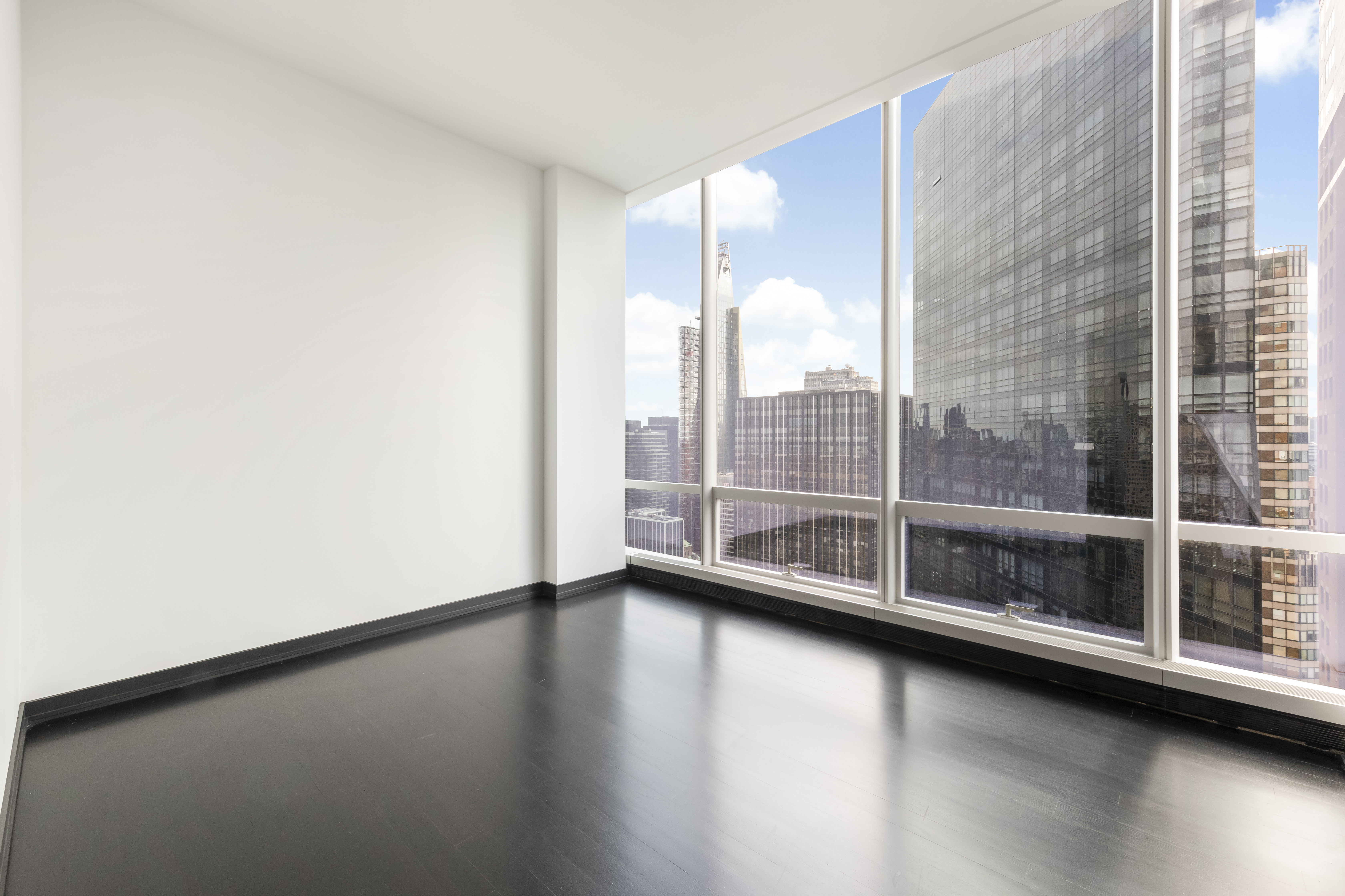157 West 57th Street, Unit 56C Manhattan, NY 10019 - Photo 10 of 12 a view of room with window
