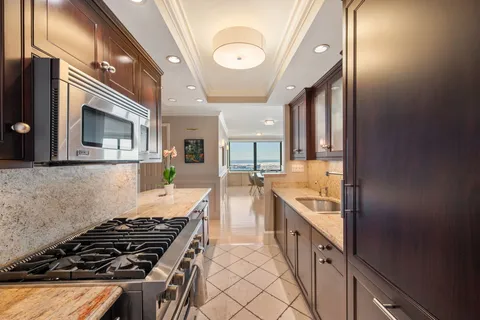 a kitchen with stainless steel appliances granite countertop a stove and a sink