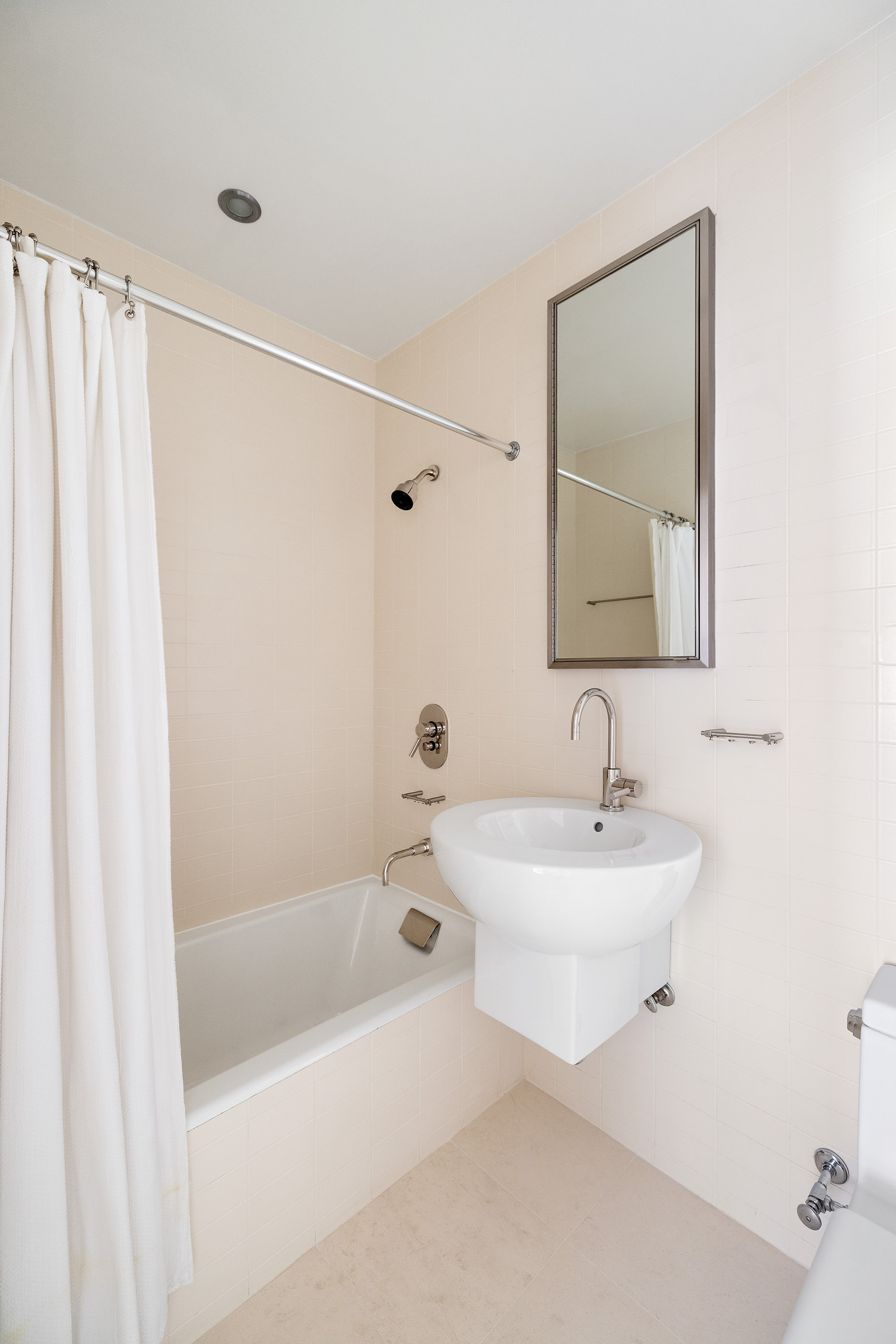 27 North Moore Street, Unit 10D Manhattan, NY 10013 - Photo 15 of 30 a bathroom with a sink a toilet and shower