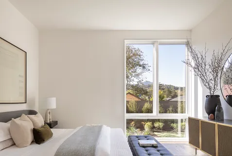 a bedroom with a bed and glass window
