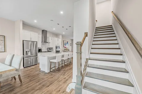 a kitchen with white cabinets and stainless steel appliances