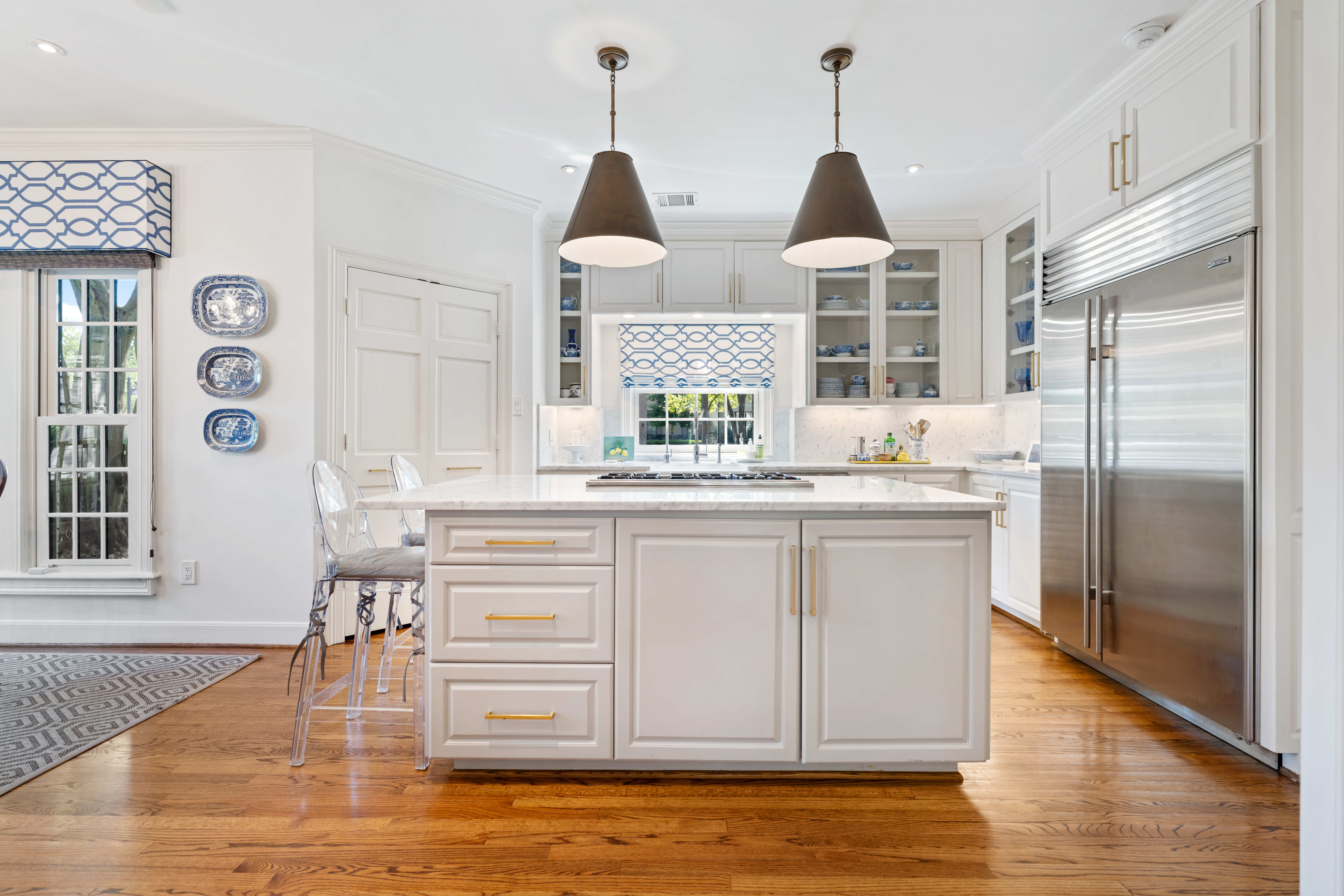 711 Pifer Road Houston, TX 77024 - Photo 3 of 53 a kitchen with kitchen island granite countertop a stove a island and a wooden floors