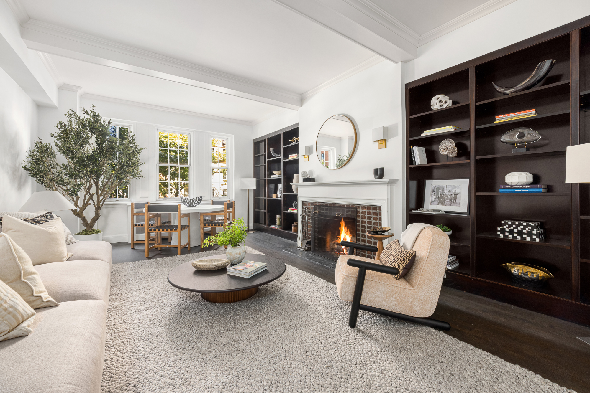 39 5th Avenue, Unit 2B Manhattan, NY 10003 - Photo 1 of 12 a living room with furniture a fireplace and a large window
