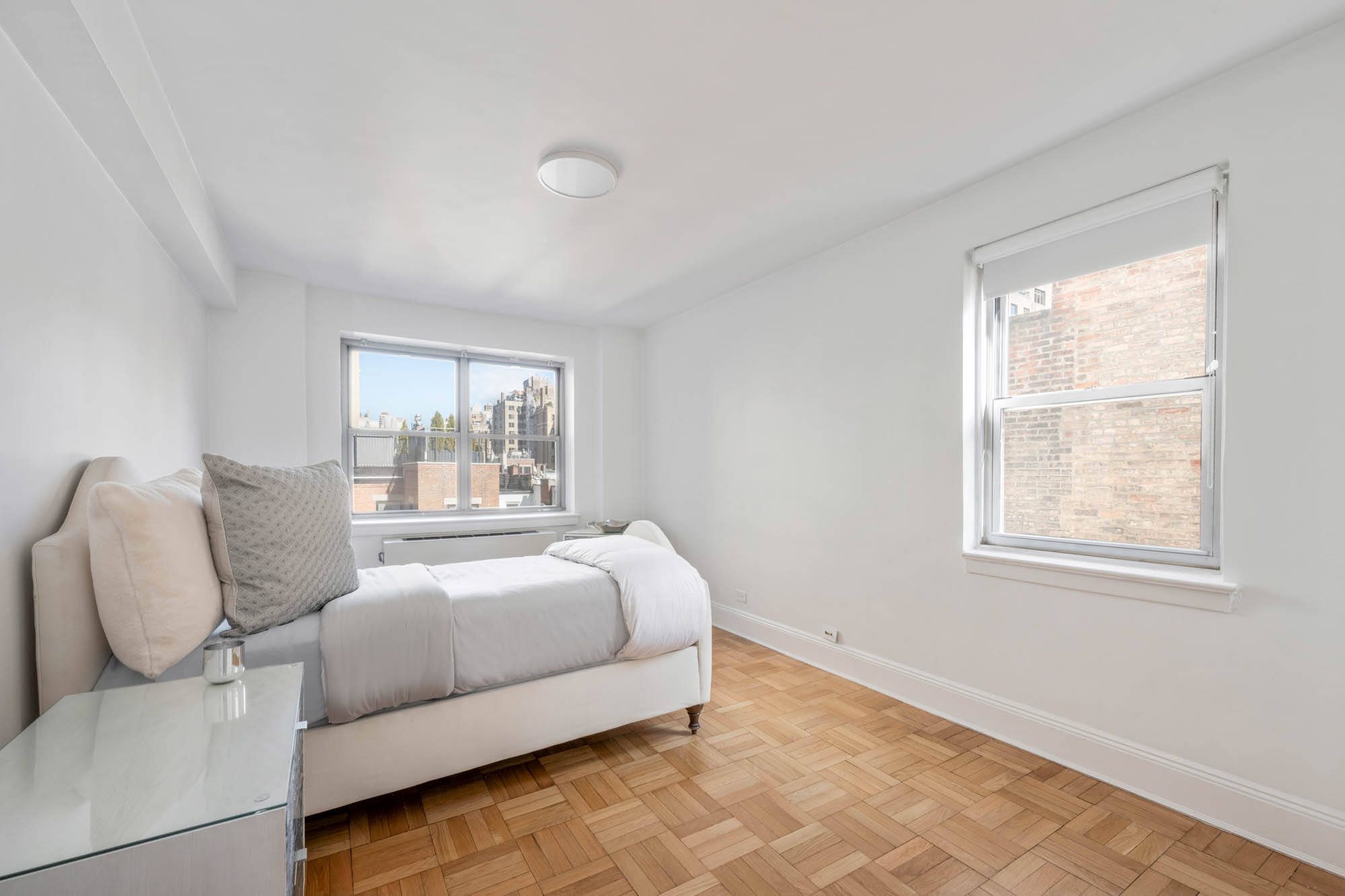 923 5th Avenue, Unit 8F Manhattan, NY 10021 - Photo 6 of 8 a bed room with a bed and a couch