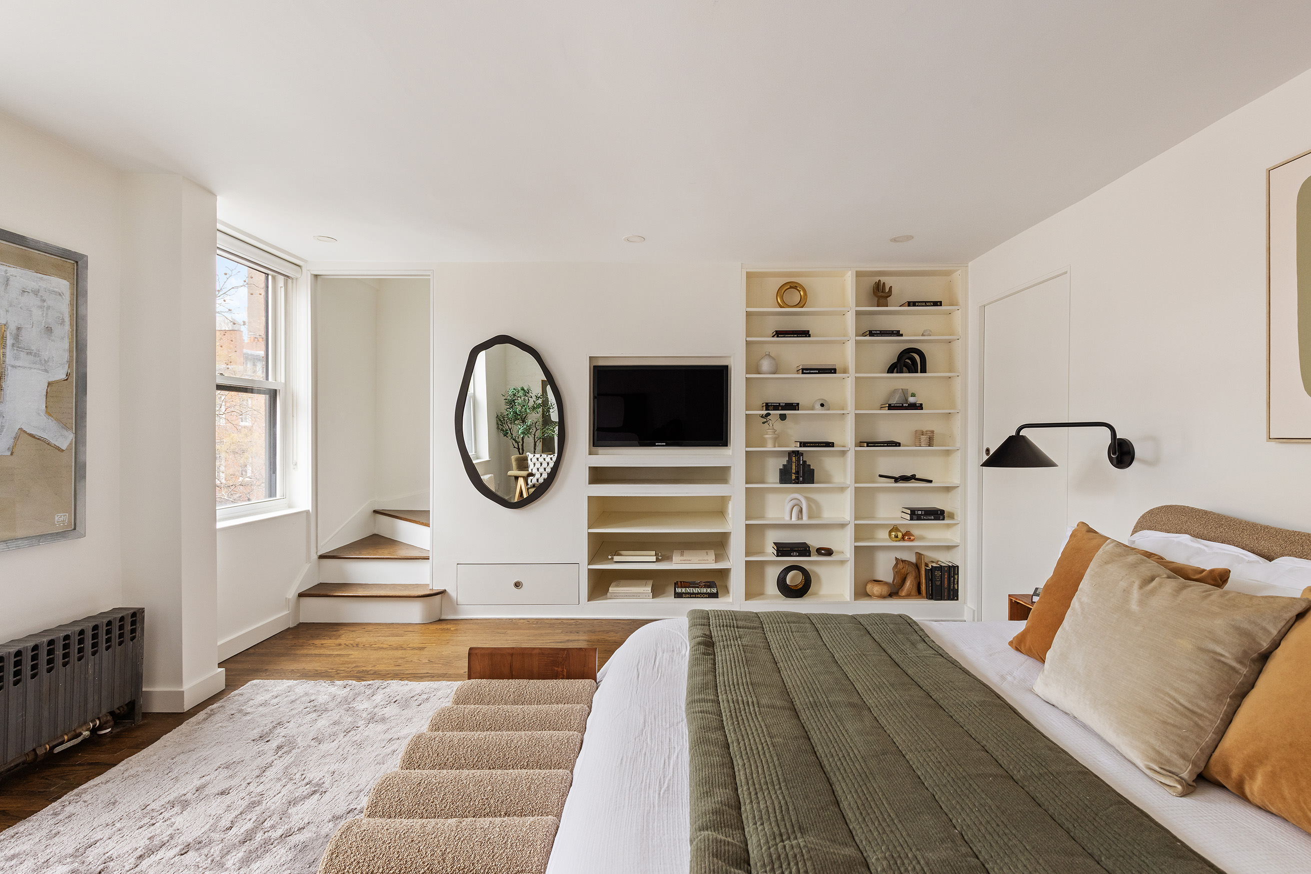 333 West 22nd Street, Unit 5A Manhattan, NY 10011 - Photo 5 of 12 a view of a bedroom with wooden floor and a window