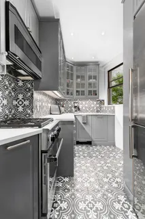 a kitchen with a sink stainless steel appliances and cabinets