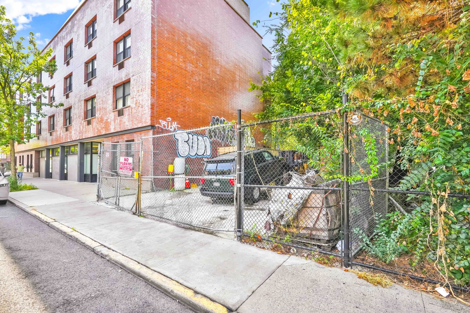 a view of a brick building next to a yard