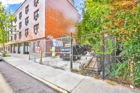 a view of a brick building next to a yard