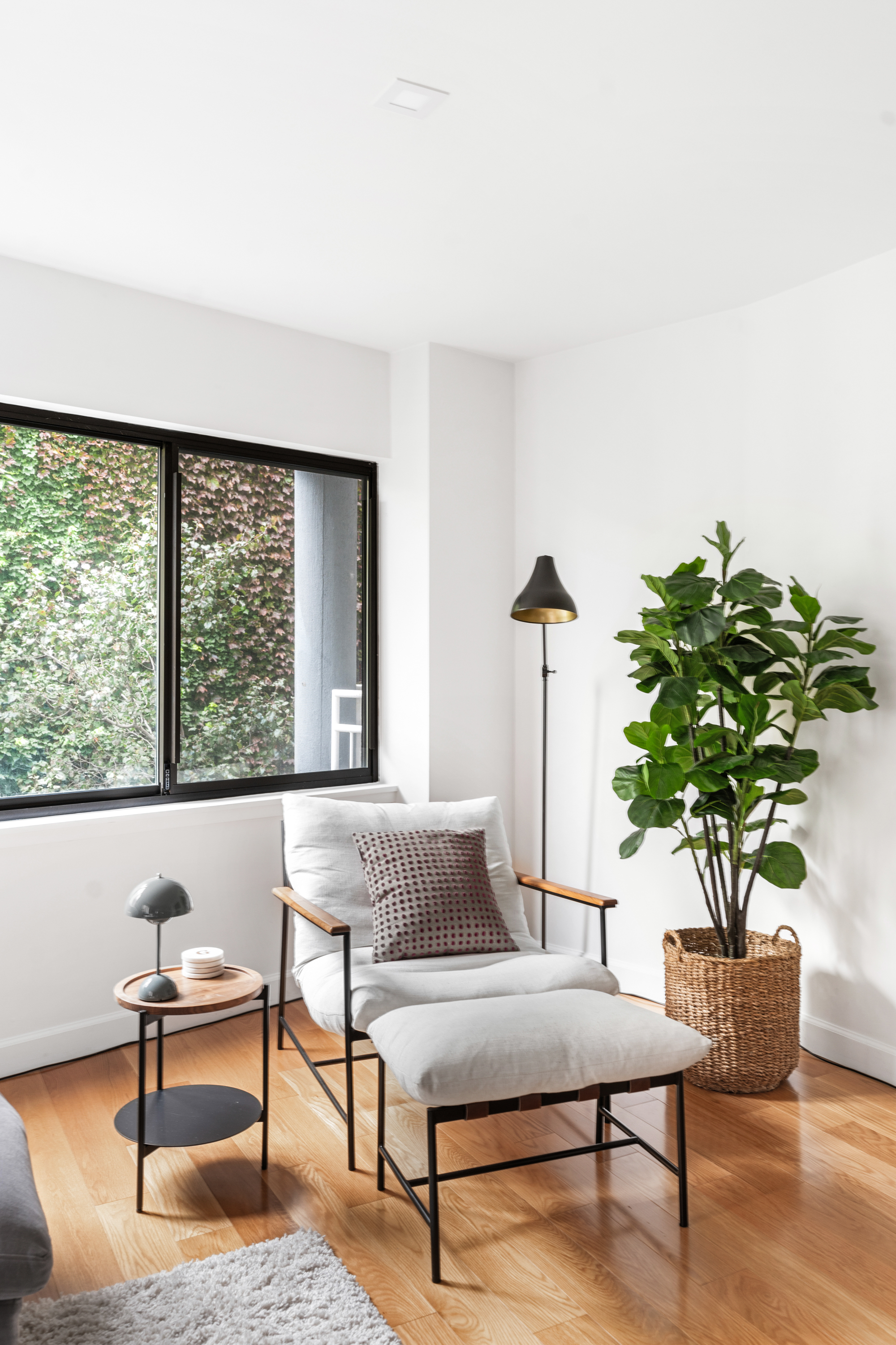 164 Bank Street, Unit 5B Manhattan, NY 10014 - Photo 4 of 11 a living room with furniture potted plant and a large window