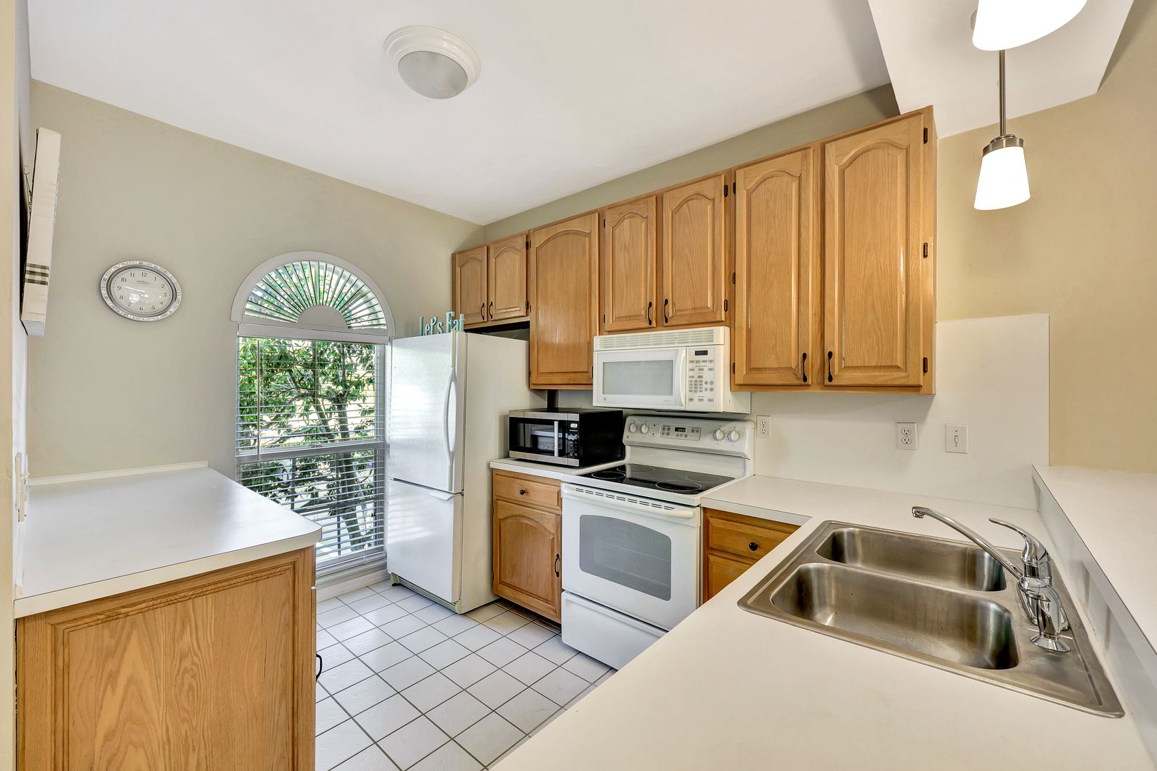 8228 Twelve Oaks Circle, Unit 323 Naples, FL 34113 - Photo 10 of 26 a kitchen that has a sink cabinets and a refrigerator