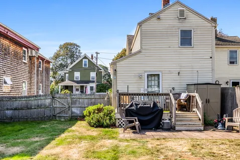 a view of a house with a yard and furniture