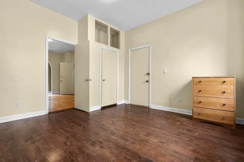 an empty room with furniture and wooden floor