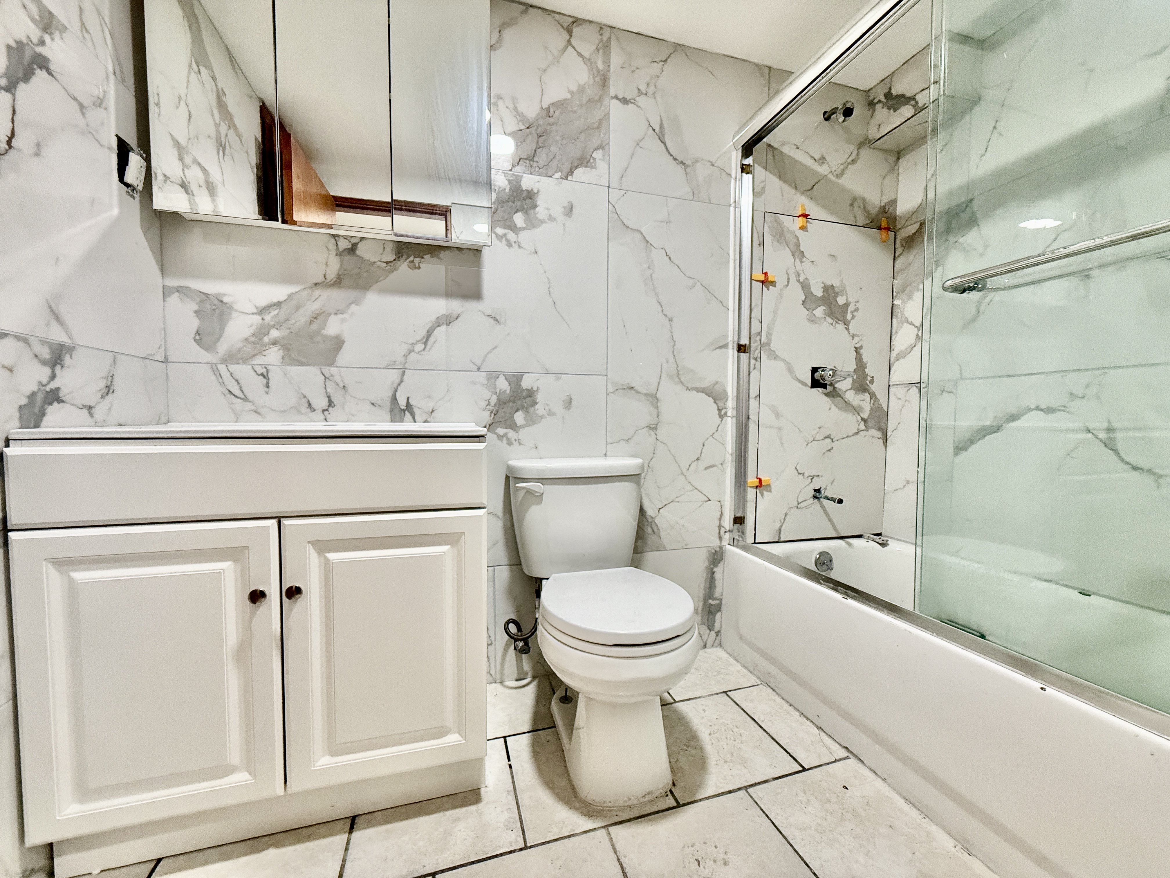 1015 Lincoln Place, Unit 1 Brooklyn, NY 11213 - Photo 6 of 7 a bathroom with a toilet sink and shower