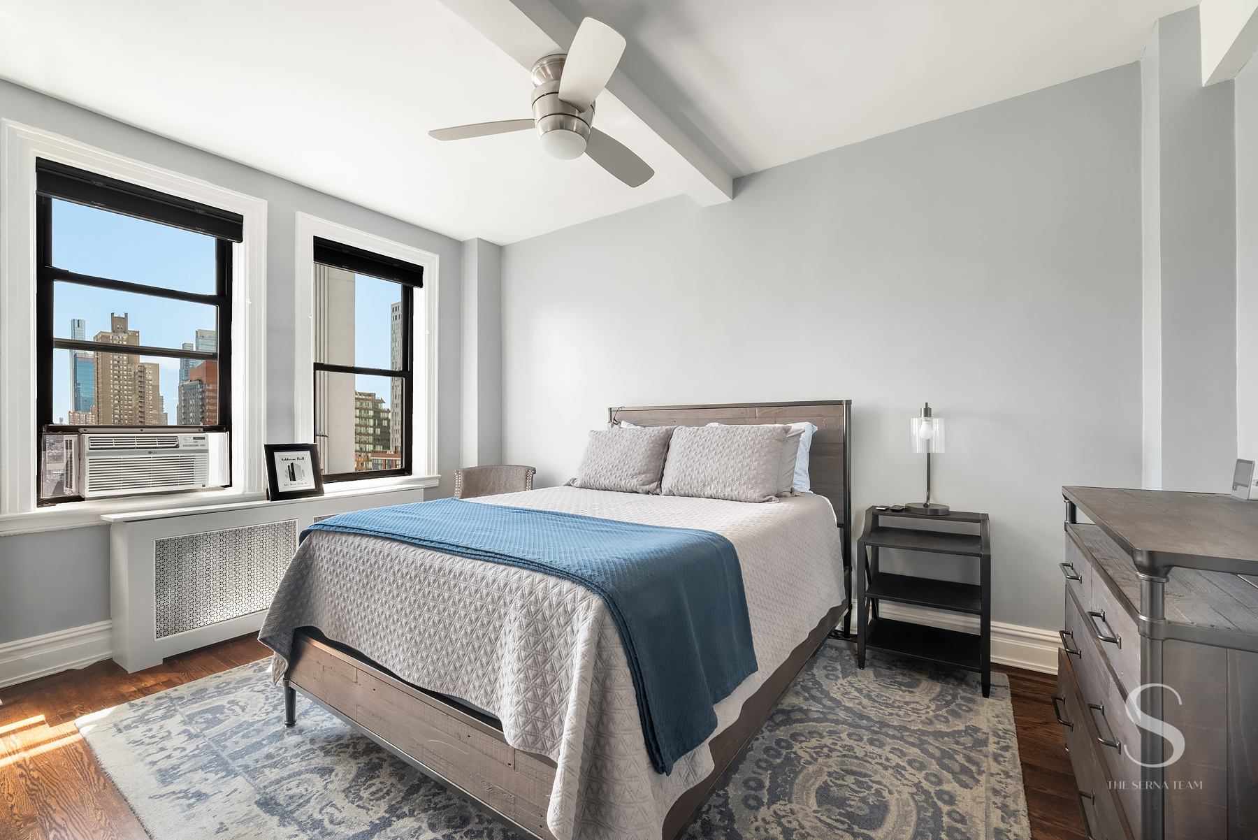 457 West 57th Street, Unit 1102 Manhattan, NY 10019 - Photo 6 of 11 a bedroom with a bed and a window