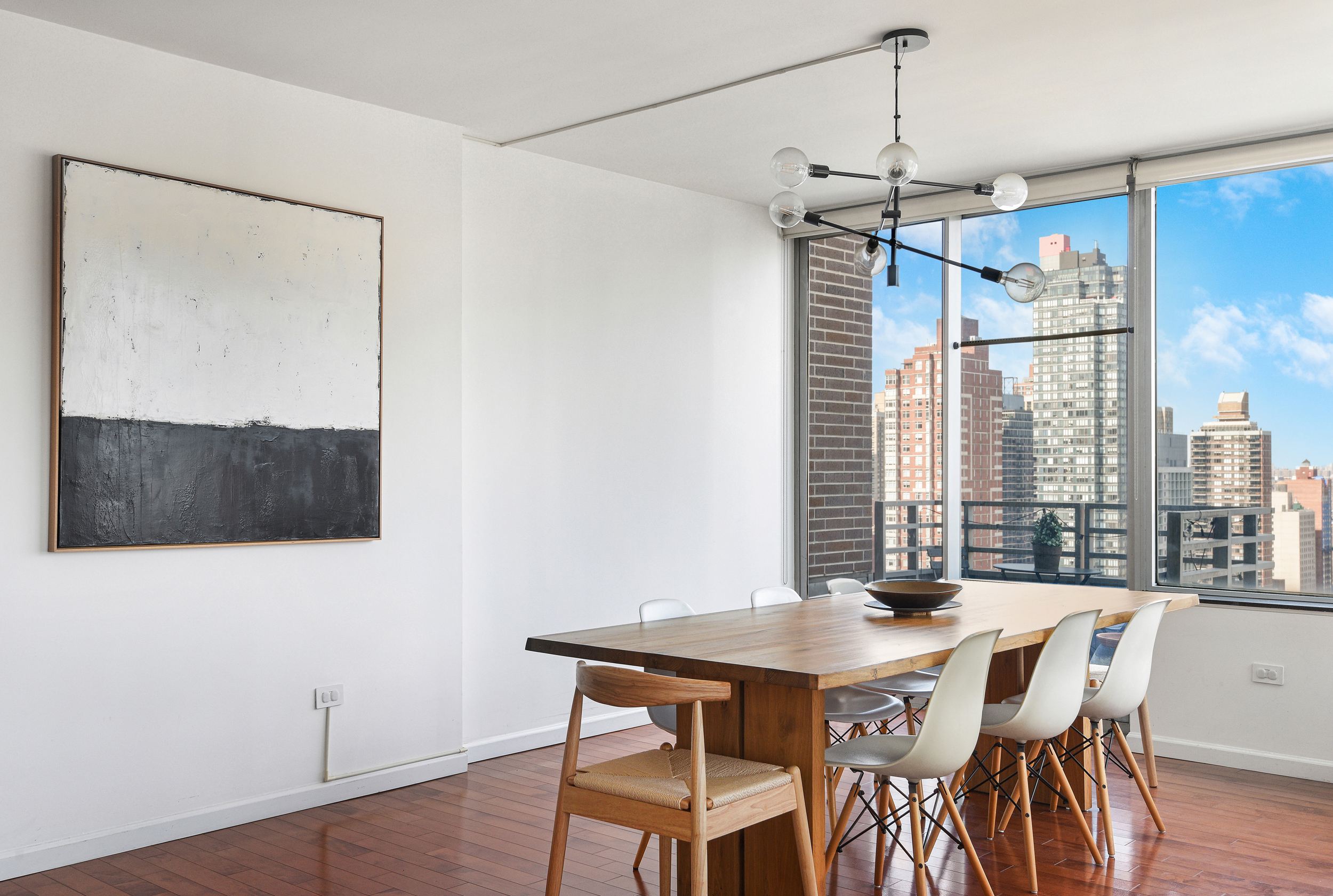 360 East 88th Street, Unit 22C Manhattan, NY 10128 - Photo 9 of 33 a view of a dining room with furniture window and wooden floor