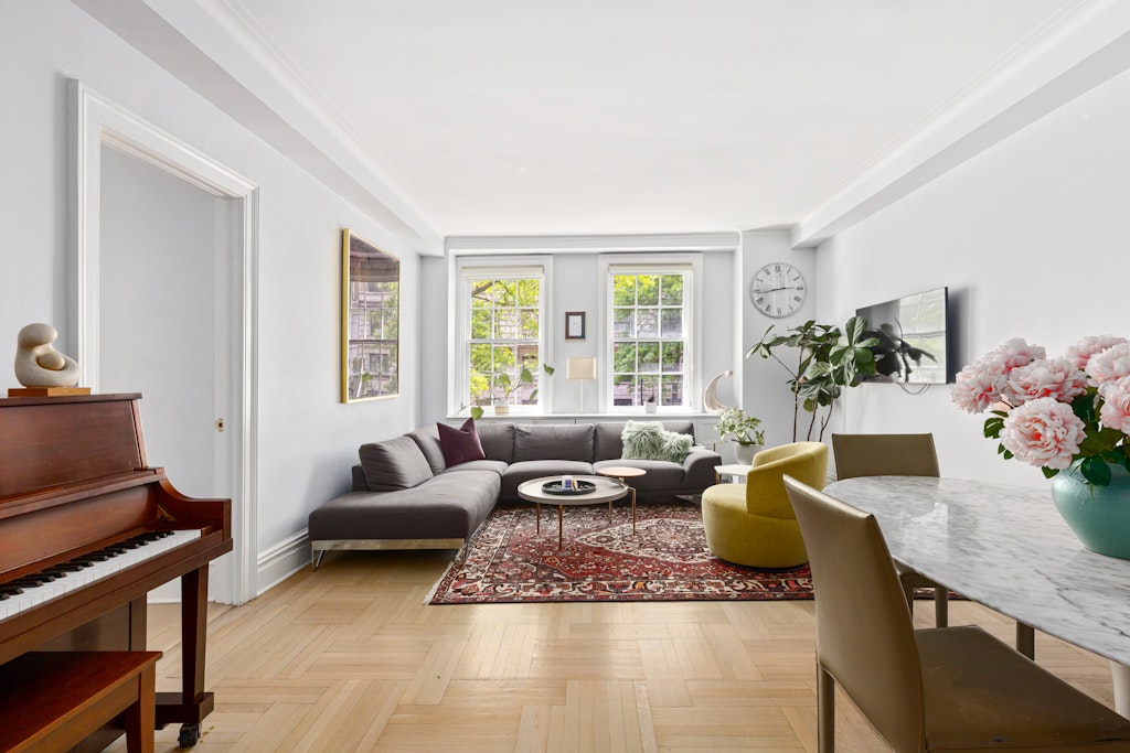 a living room with furniture potted plant and a window