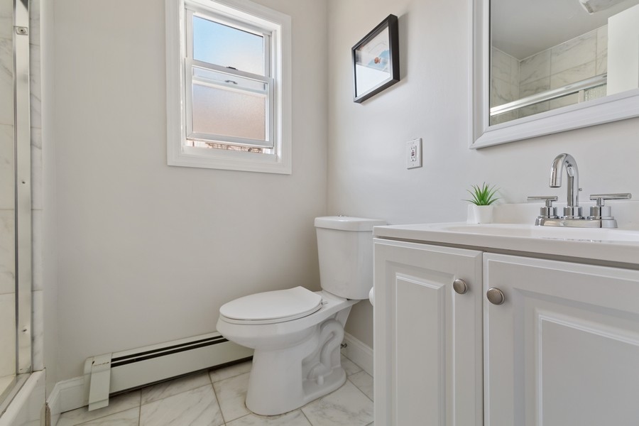 671 Metropolitan Avenue, Unit Undisclosed Brooklyn, NY 11211 - Photo 12 of 13 a bathroom with a sink a toilet and a mirror