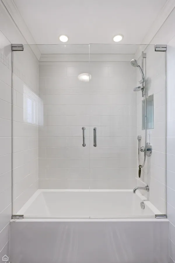 a bathroom with a shower and a bath tub