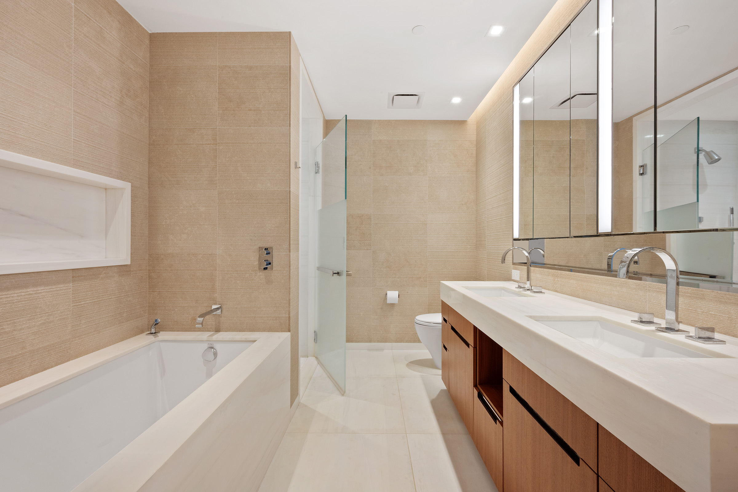 1 West End Avenue, Unit 14G Manhattan, NY 10023 - Photo 5 of 27 a bathroom with a tub sink and mirror