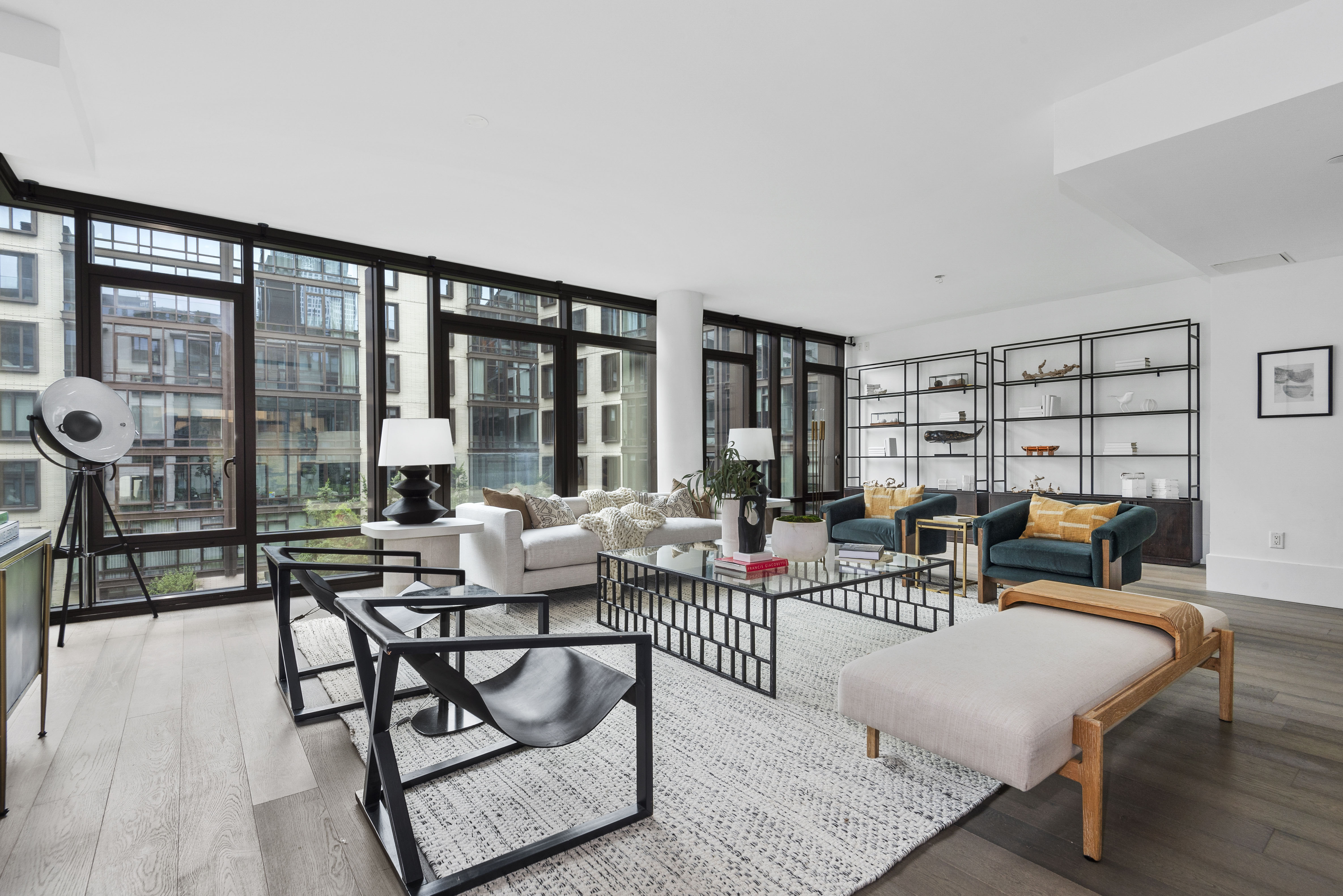 a living room with furniture and large windows