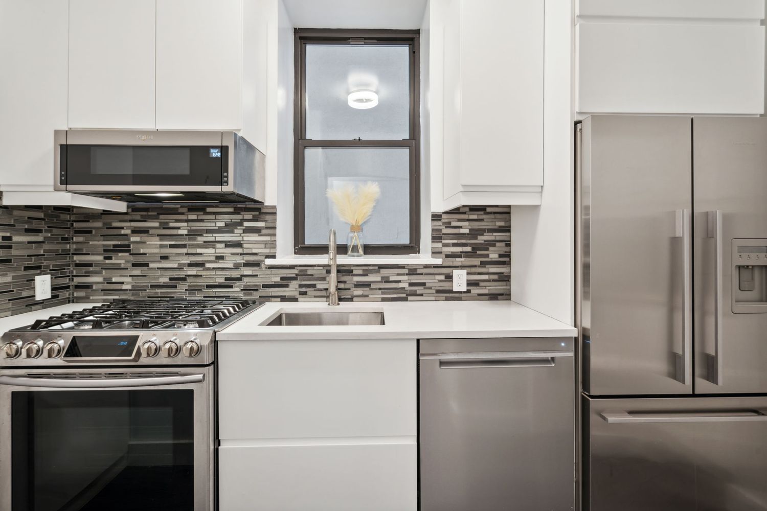 a kitchen with a sink stove and refrigerator