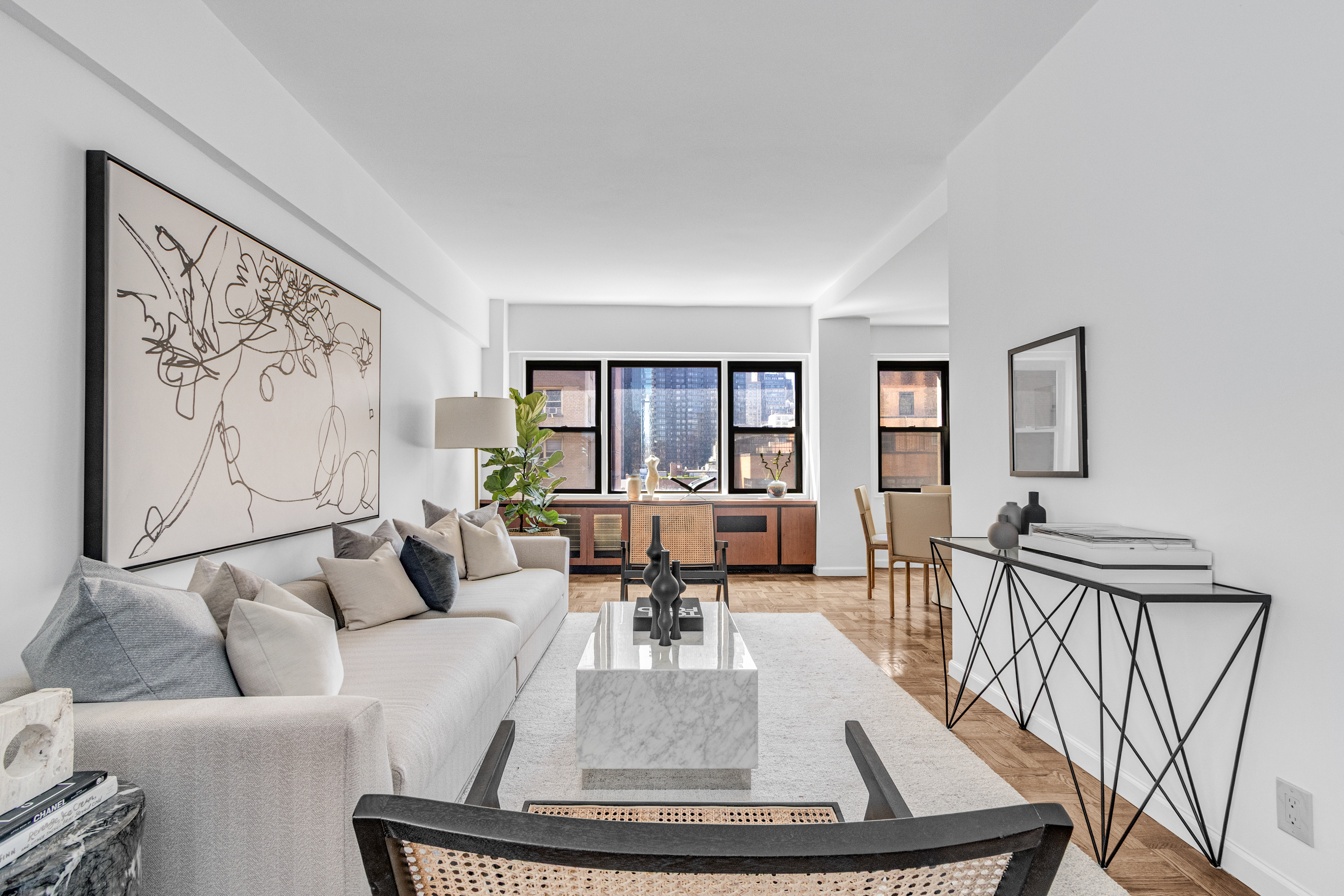 a living room with furniture and a view of kitchen