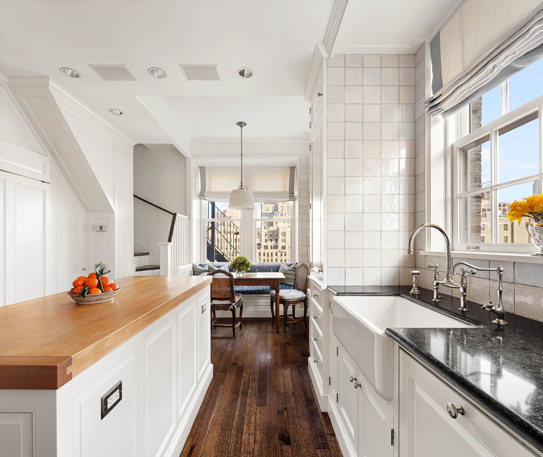 953 5th Avenue, Unit PH Manhattan, NY 10075 - Photo 10 of 27 a very nice looking kitchen with granite countertop a sink counter space and wooden floor