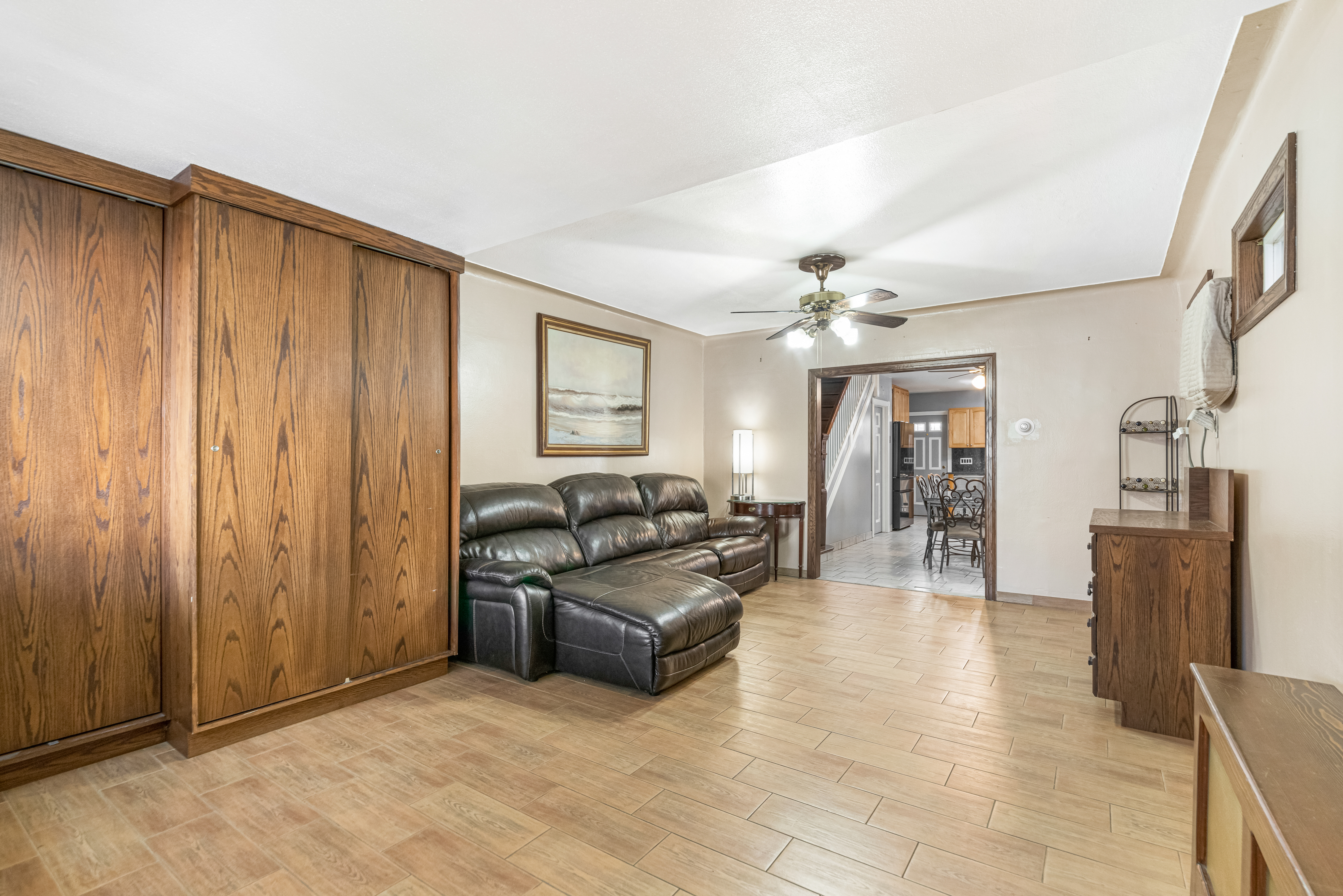 1874 Ryder Street Brooklyn, NY 11234 - Photo 3 of 20 a living room with furniture a chandelier and a flat screen tv