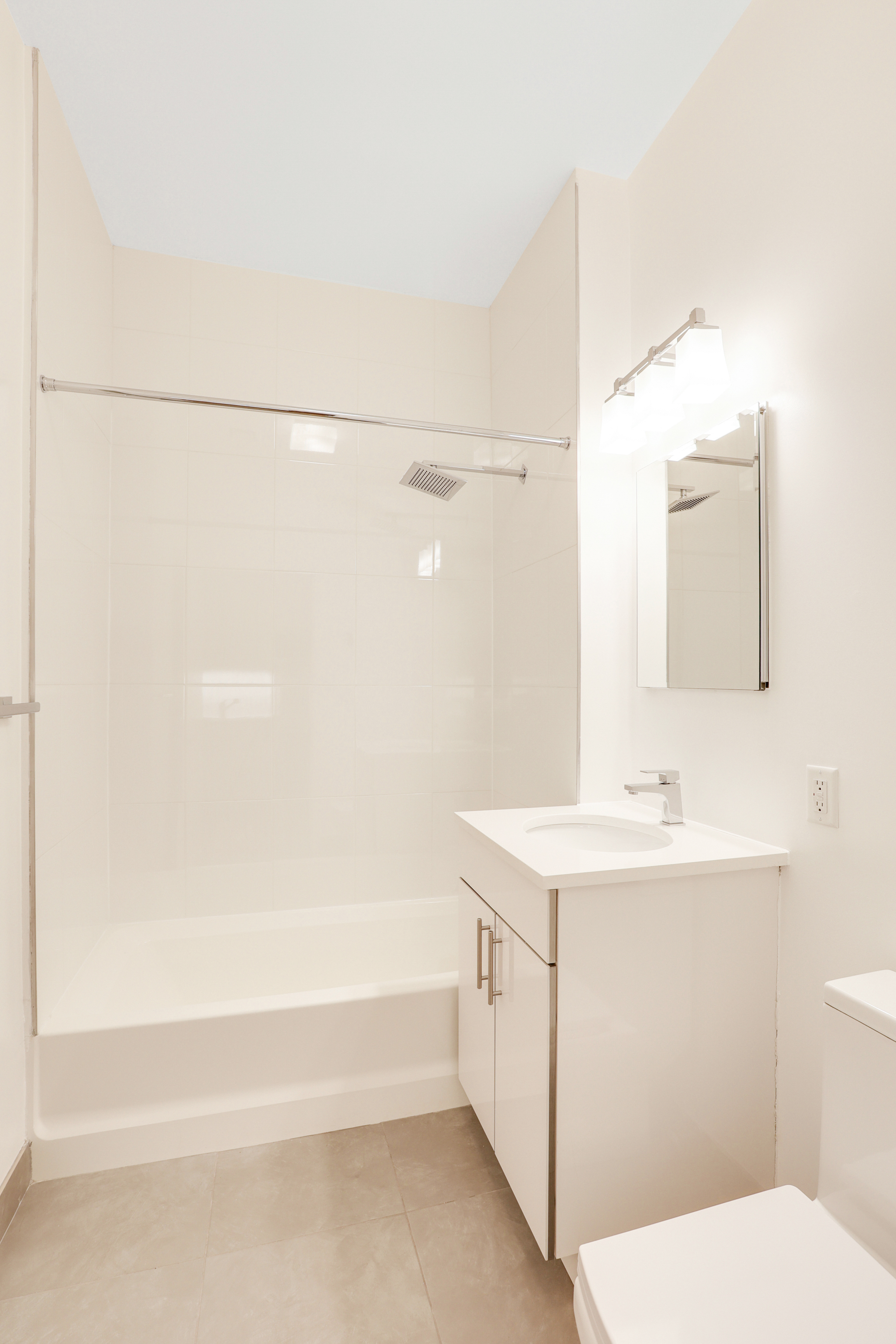 230 West 75th Street, Unit 1 Manhattan, NY 10023 - Photo 7 of 9 a bathroom with a sink a toilet and shower