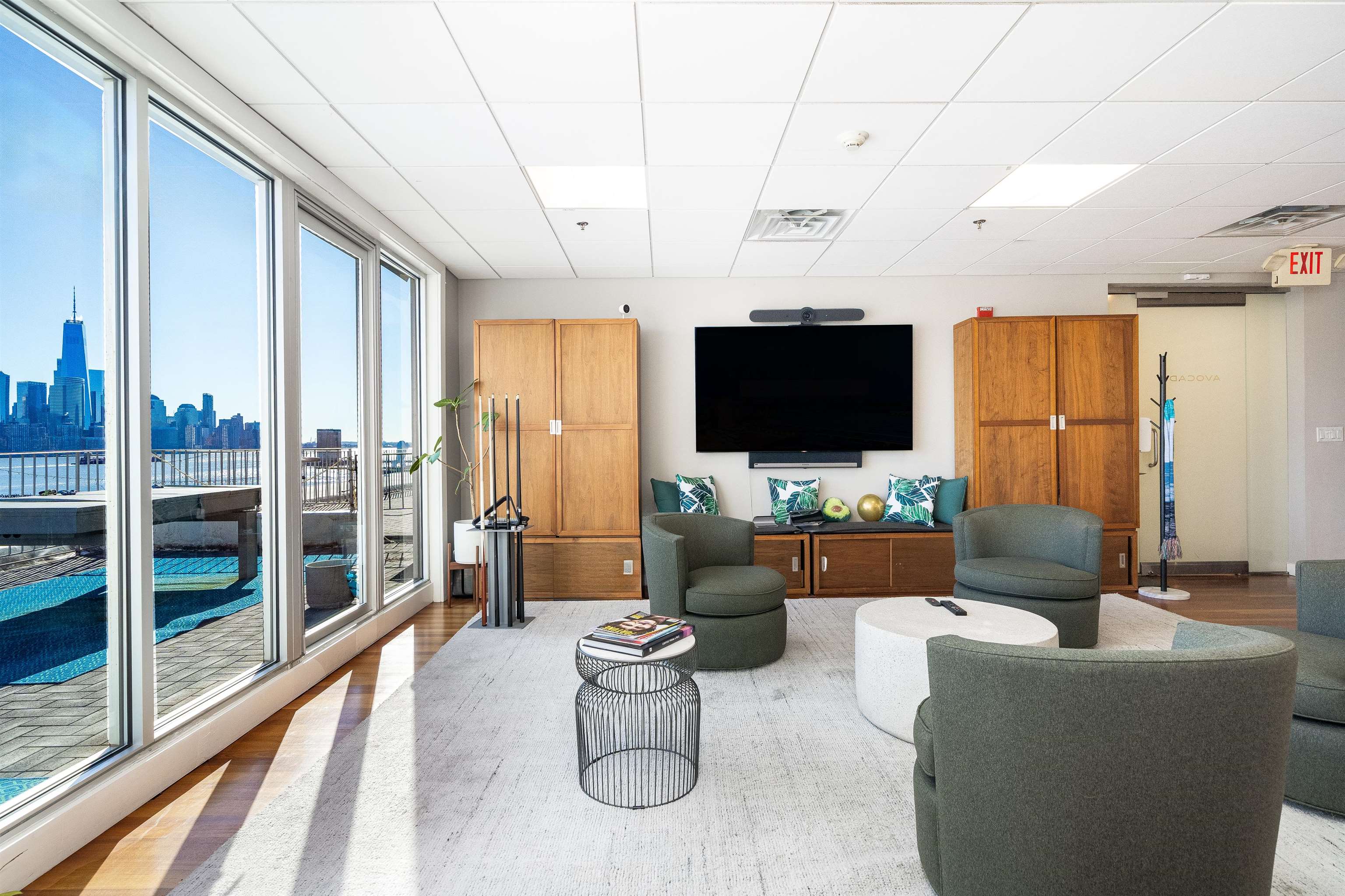 80 River Street, Unit PHNORTH Hoboken, NJ 07030 - Photo 4 of 24 a living room with furniture a flat screen tv and a floor to ceiling window