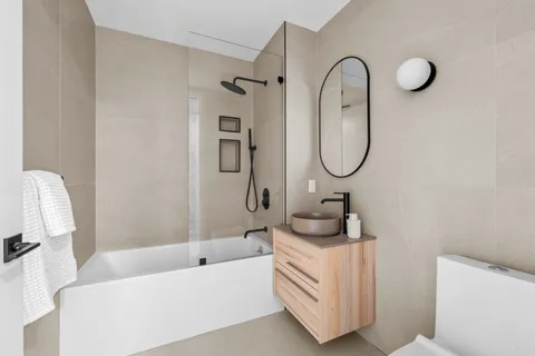 a bathroom with a sink a toilet and a tub