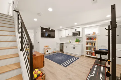 a living room with furniture a flat screen tv and a table