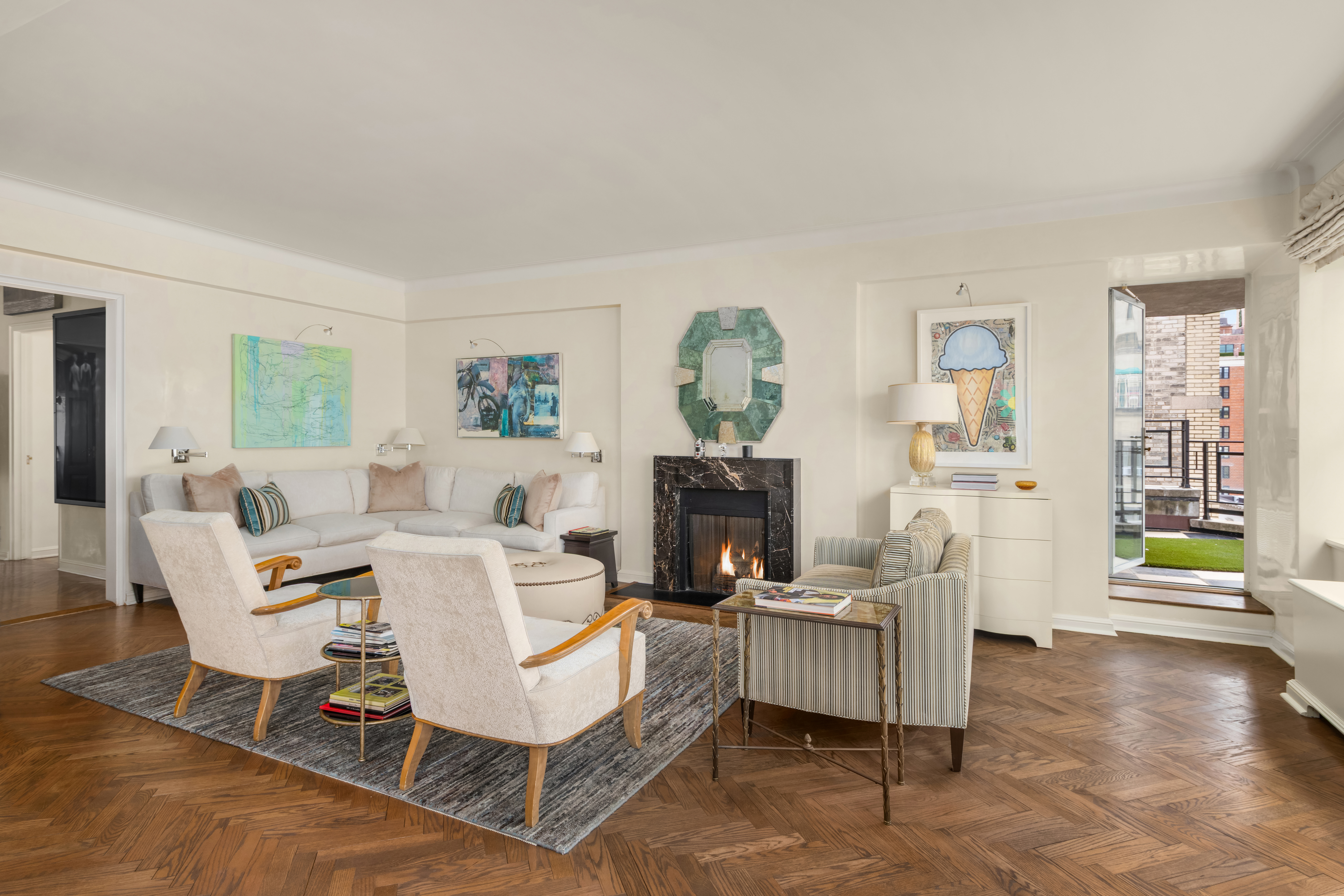 1 East 66th Street, Unit 9EF Manhattan, NY 10065 - Photo 4 of 19 a living room with furniture and a wooden floor