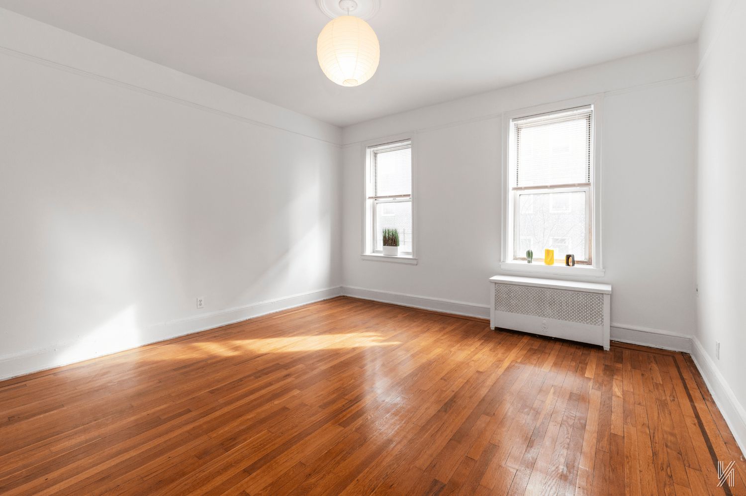 59-11 Queens Boulevard, Unit 3J Queens, NY 11377 - Photo 13 of 18 an empty room with wooden floor and windows