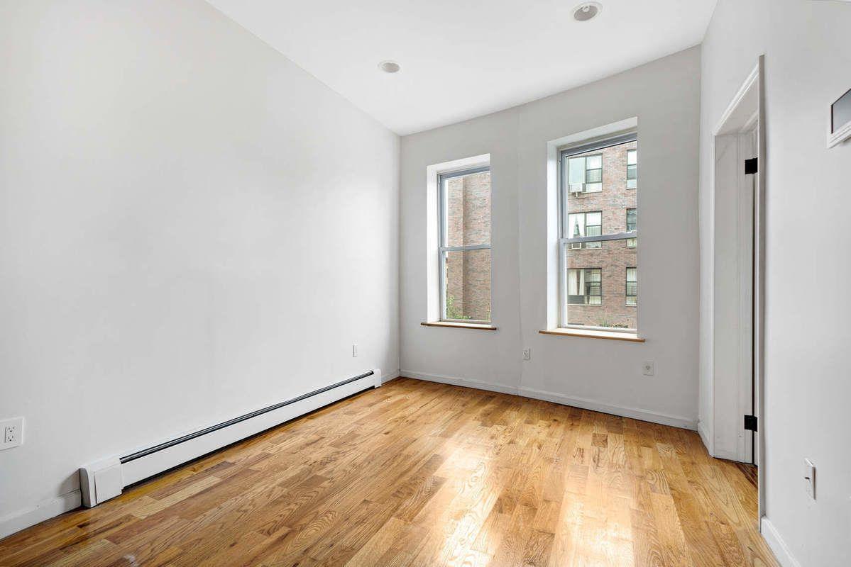 1235 Decatur Street, Unit 2 Brooklyn, NY 11207 - Photo 6 of 13 an empty room with windows