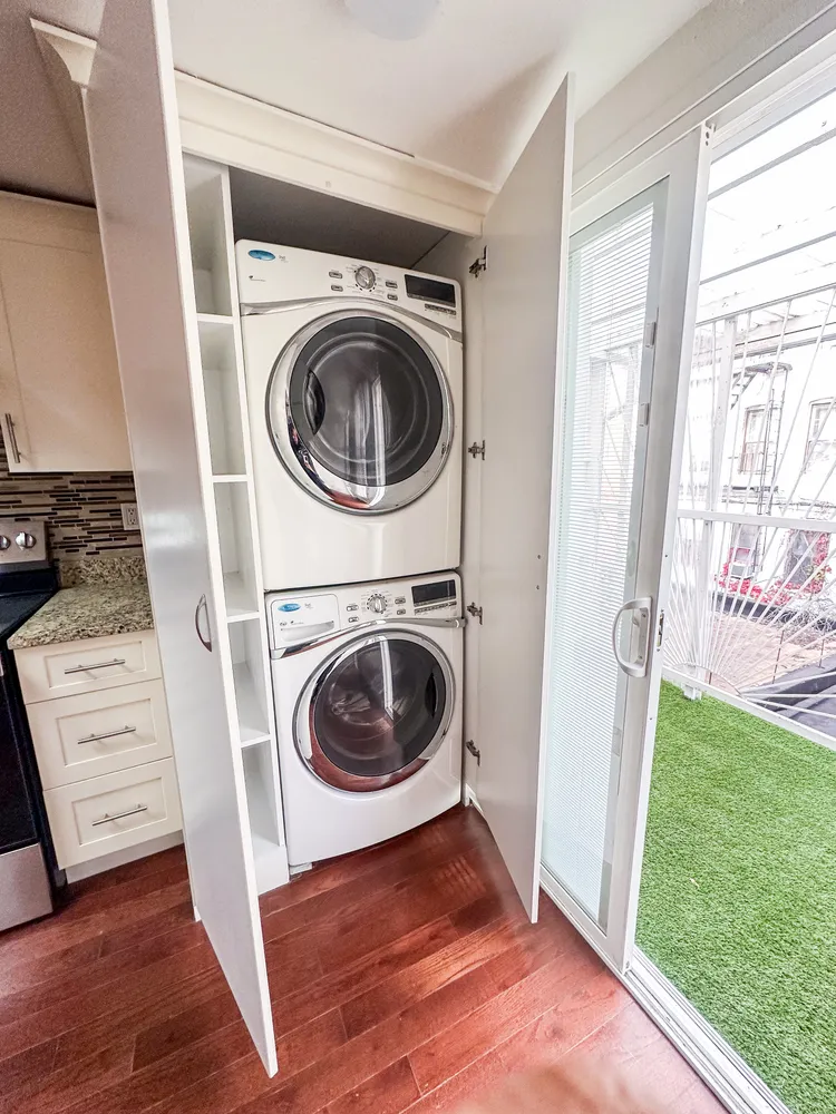 a view of a hallway with washer and dryer