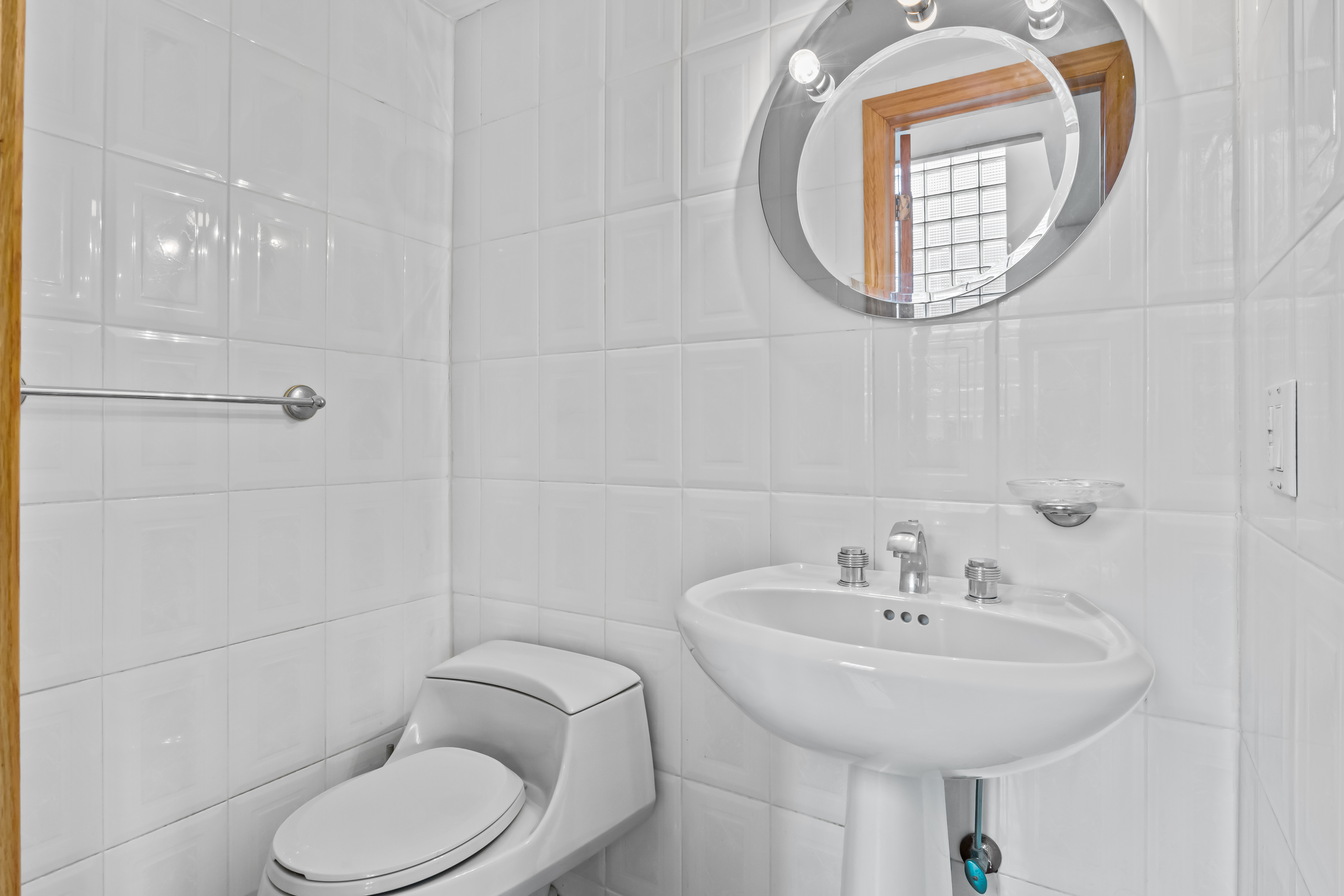 303 Whitman Drive Brooklyn, NY 11234 - Photo 30 of 37 a bathroom with a toilet sink and mirror