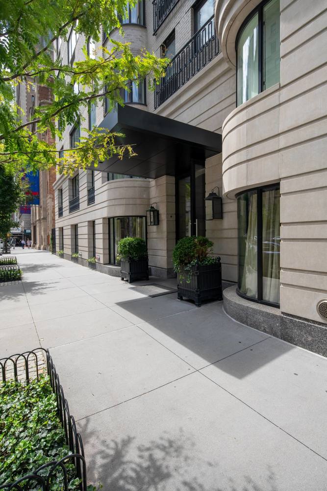 530 Park Avenue, Unit 14D Manhattan, NY 10065 - Photo 12 of 12 a front view of a building with lots of green space