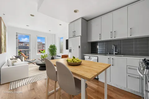 a kitchen with a table chairs stove and kitchen island