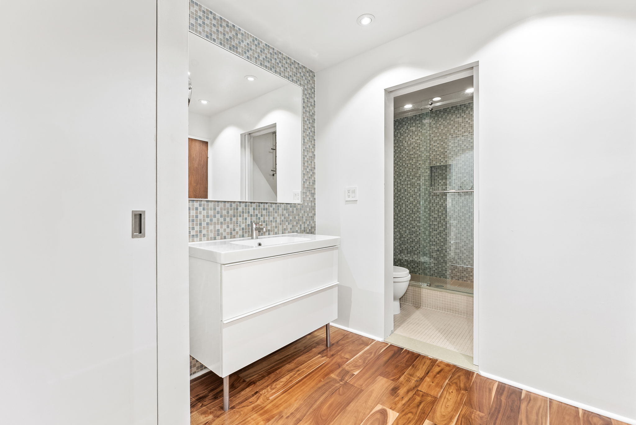 310 East 46th Street, Unit 5T Manhattan, NY 10017 - Photo 8 of 13 a bathroom with a granite countertop sink toilet and shower