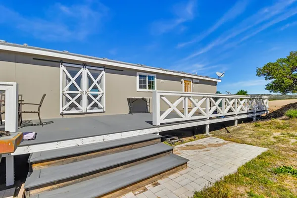 a front view of a house with trees
