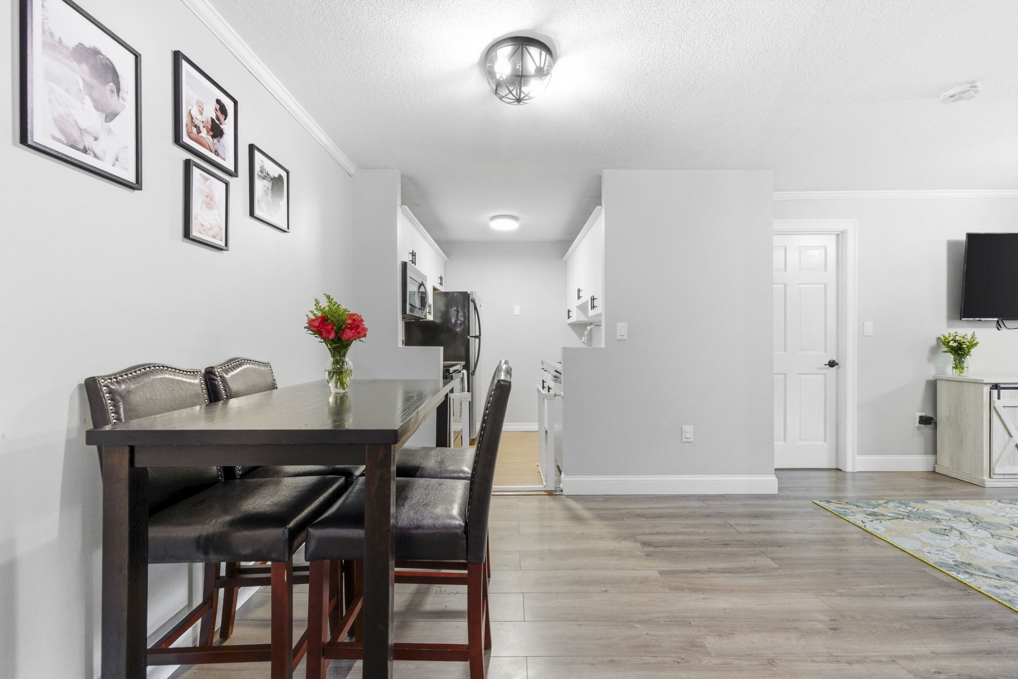 61 Wright Street, Unit 102 Stoneham, MA 02180 - Photo 6 of 26 a view of a dining room with furniture and wooden floor