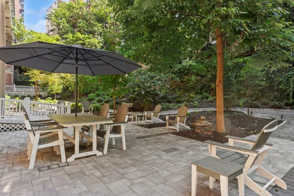 a view of a patio with a table and chairs under an umbrella